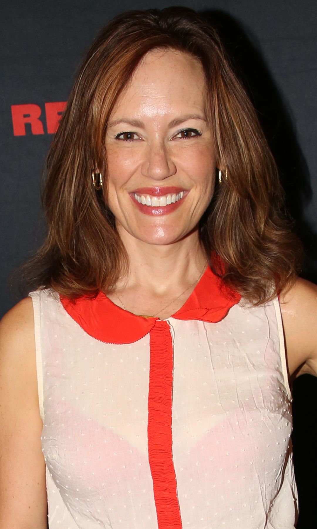 Emilt Swallow in a semi-sheer shirt and denim jeans