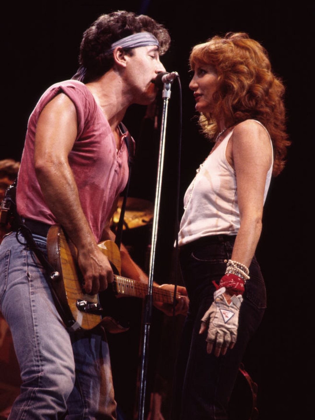Bruce Springsteen, on guitar, and backing vocalist Patti Scialfa of the E Street Band, perform onstage during the 'Born in the USA' tour in 1985. 