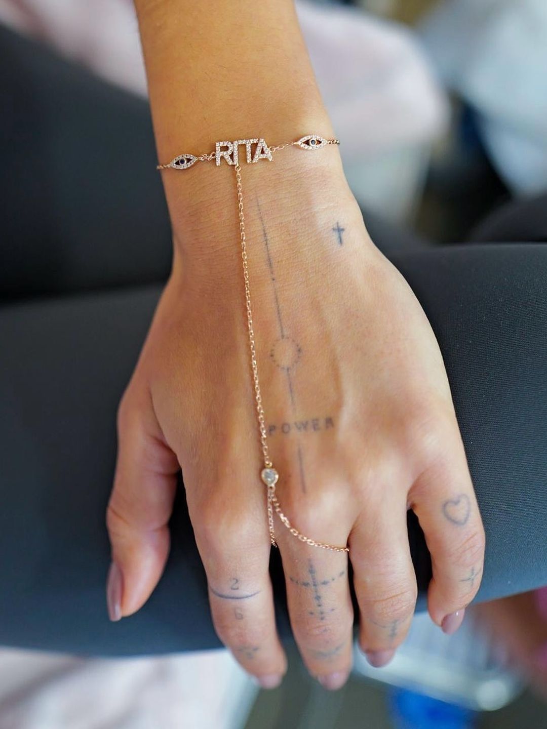 A close up of Rita Ora's delicate hand bracelet 