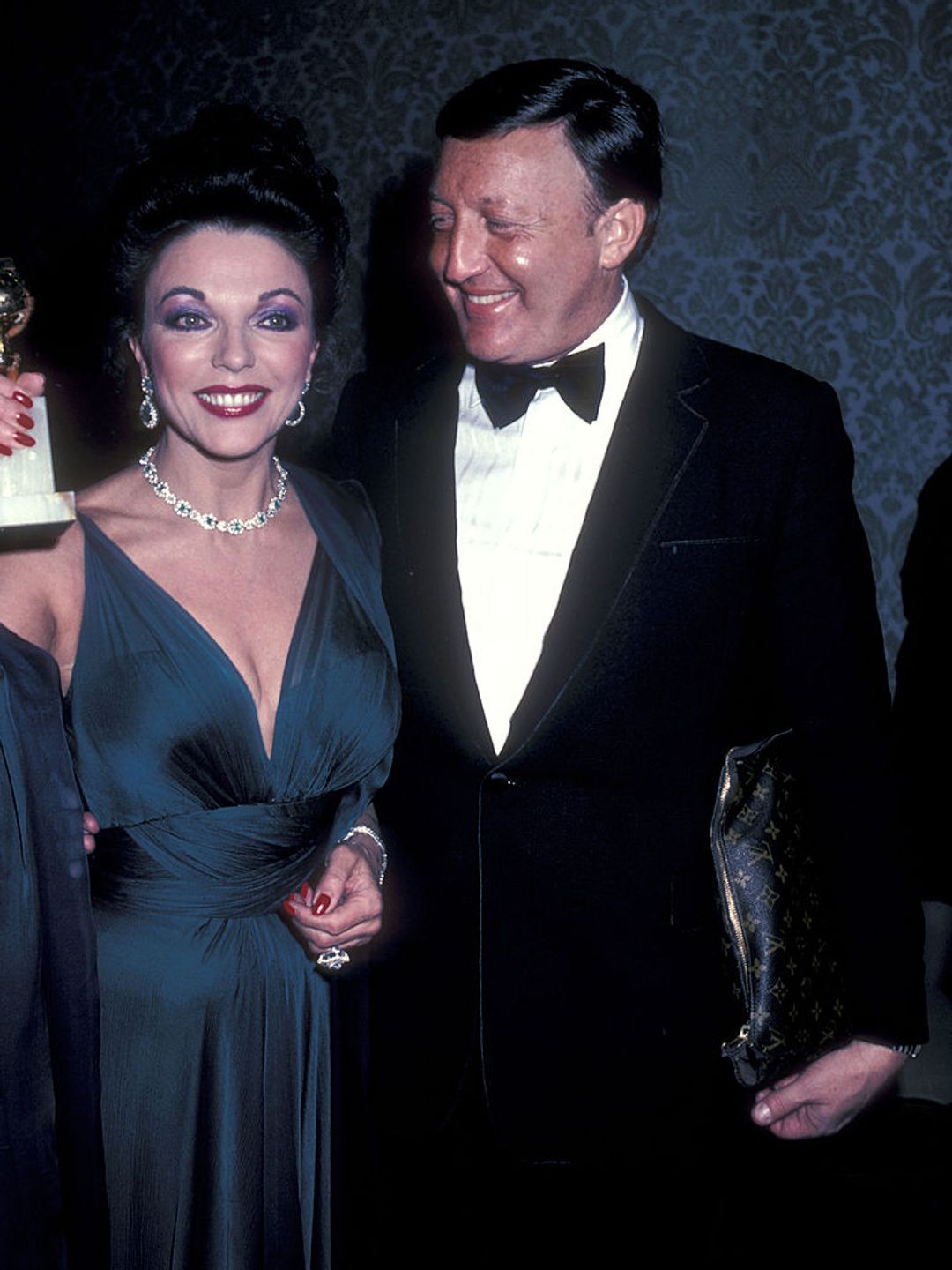 Actress Joan Collins and husband Ronald S. Kass attend the 40th Annual Golden Globe Awards on January 29, 1983