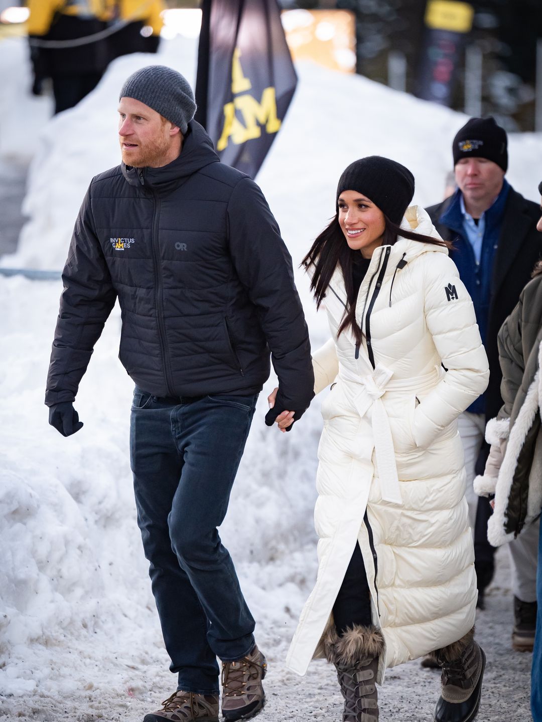 two people walking through snow