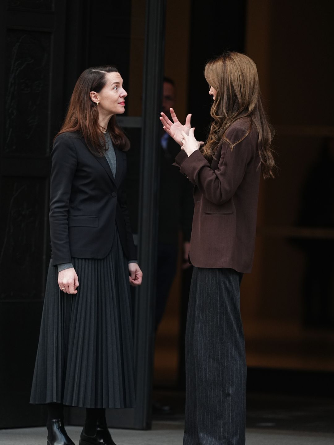 two women chatting outside gallery