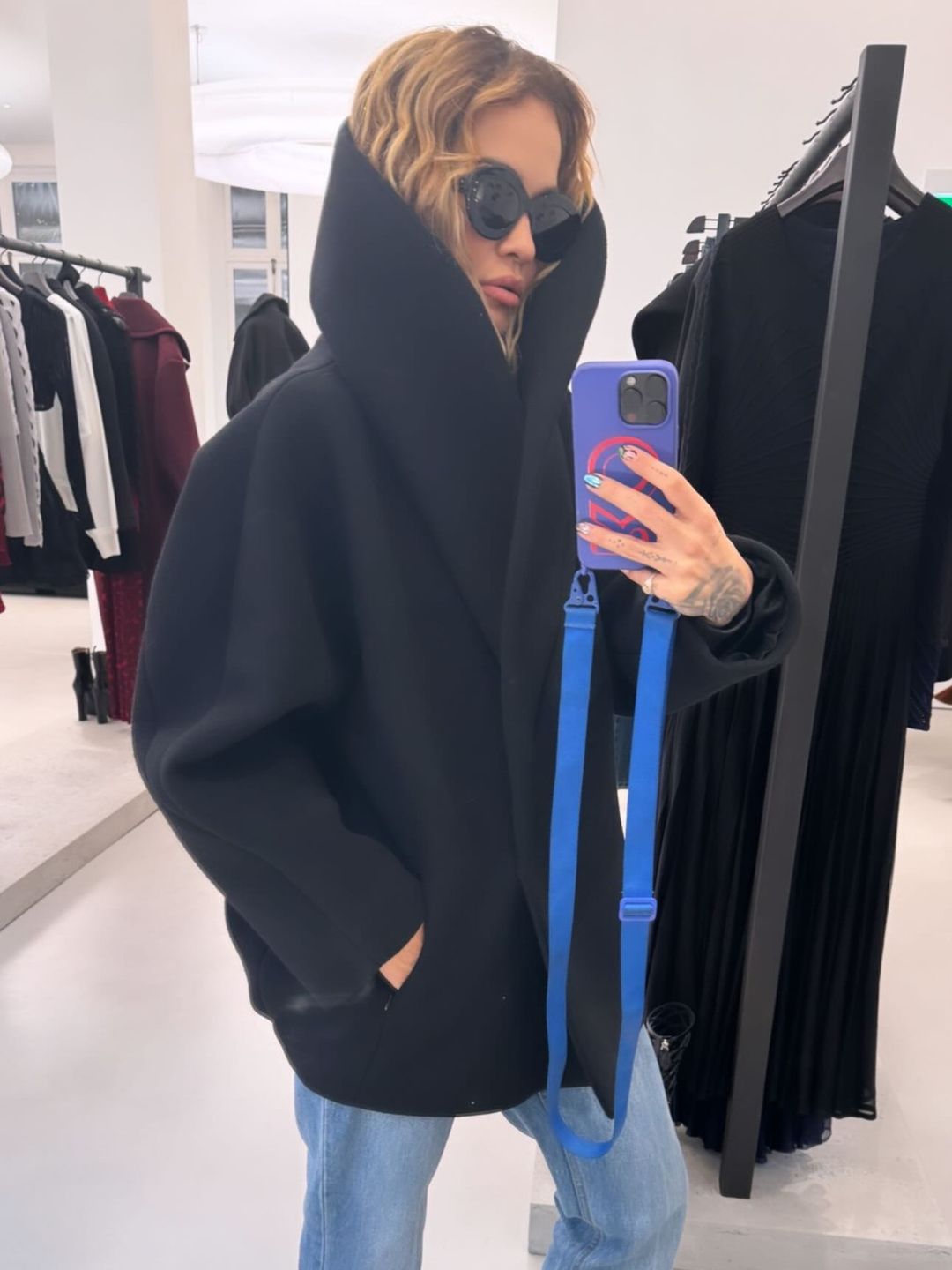 Rita Ora's Instagram story posing in front of a mirror wearing her new coat