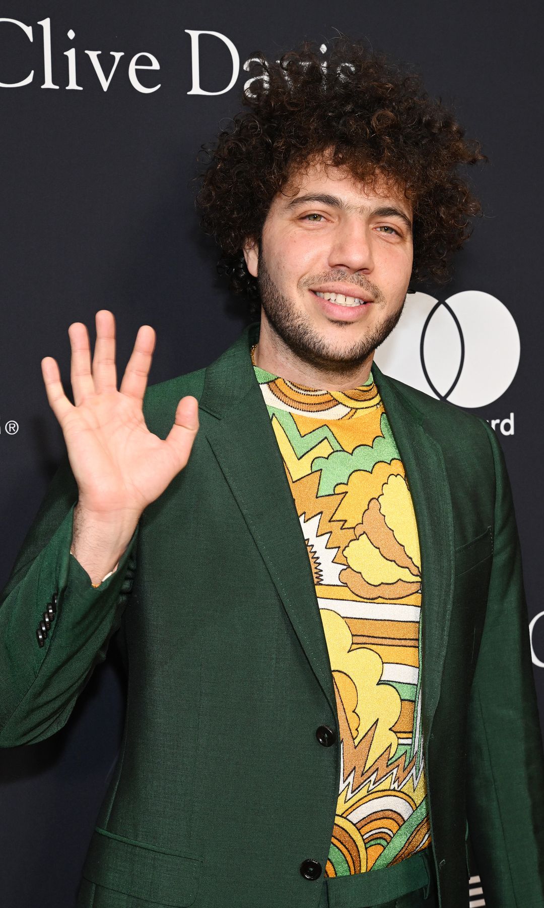Benny Blanco at the Pre-GRAMMY Gala held at The Beverly Hilton on February 3, 2024 in Los Angeles, California in a green suit