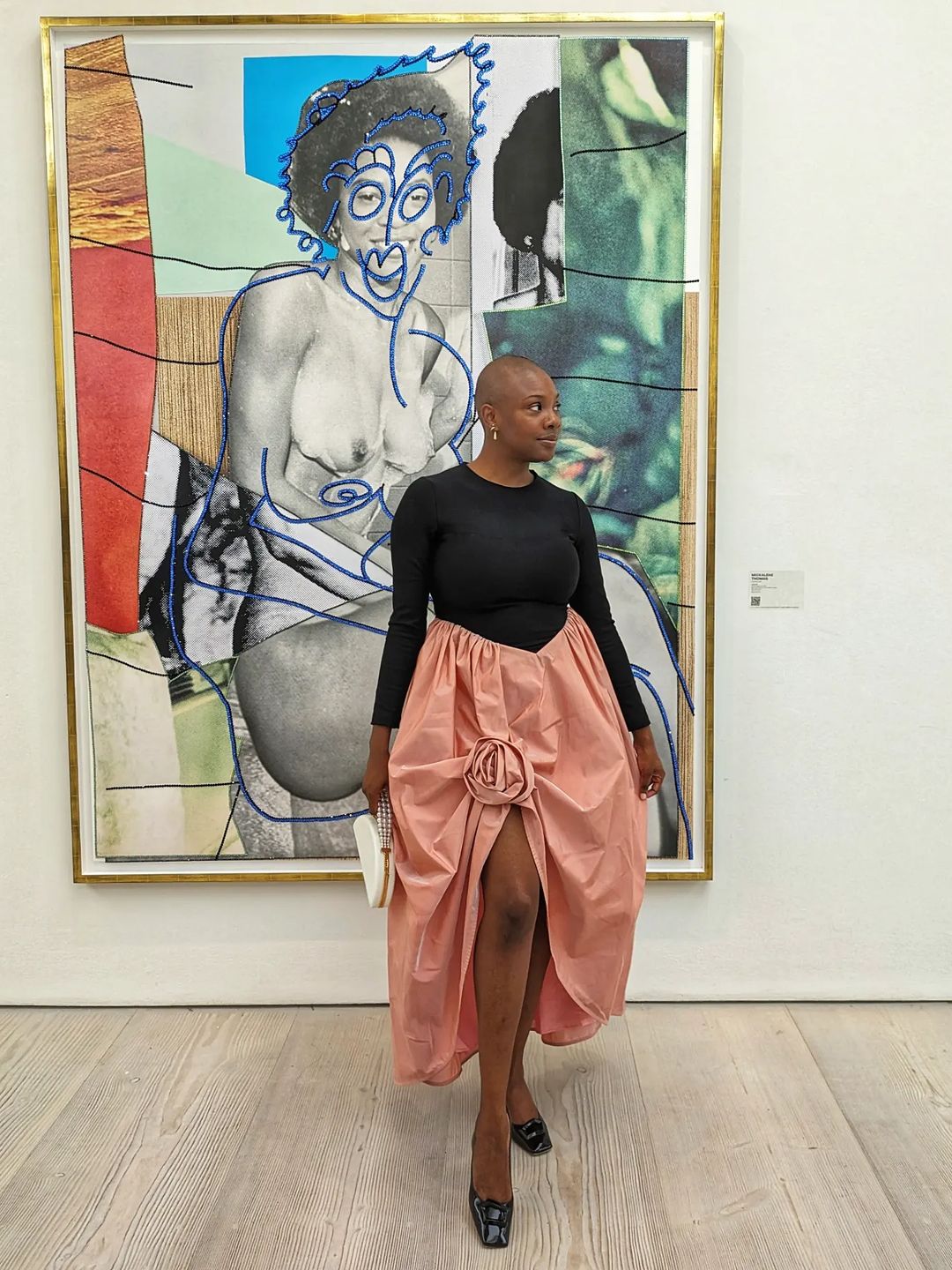 Yomi Adegoke attends a gallery opening in a black and pink dress