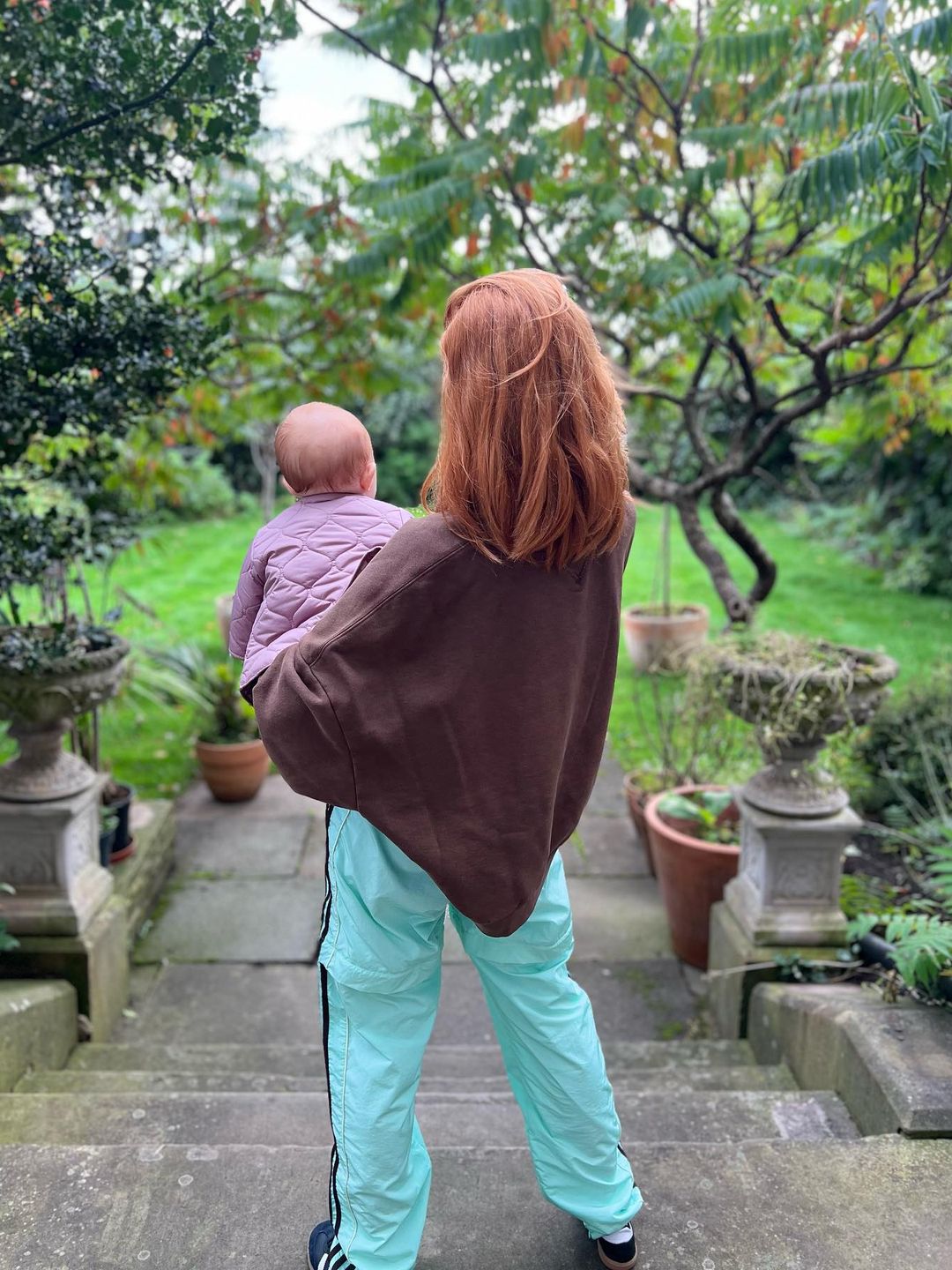 stacey dooley holding baby on steps 
