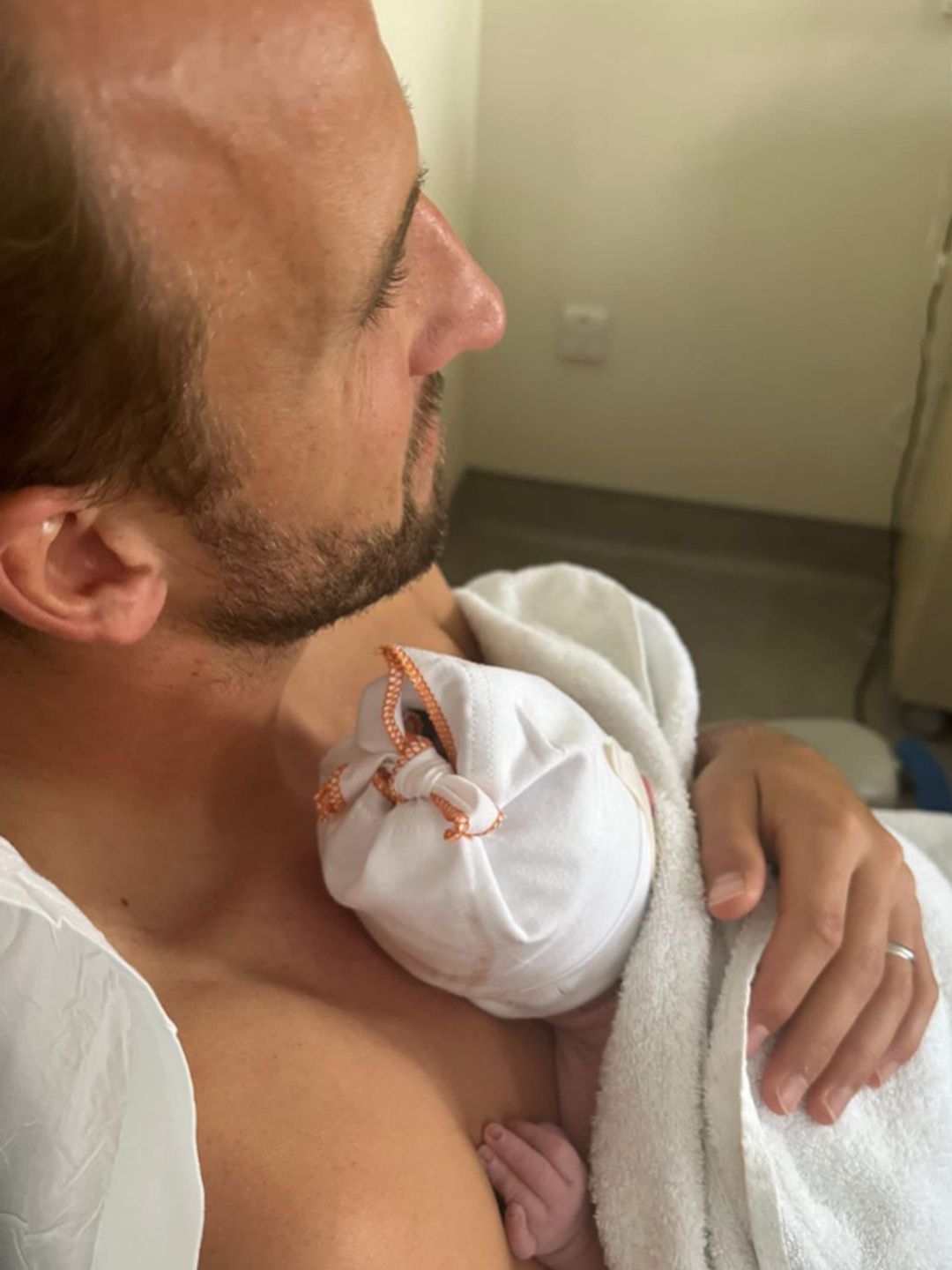 Harry Kane holding a baby boy