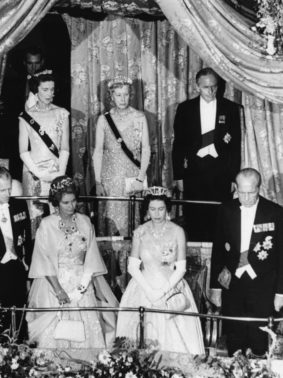 Princess Mary (stood behind Queen Elizabeth II) wore the Harewood Fringe to an event at the Aldwych Theatre in London on July 11 1963.