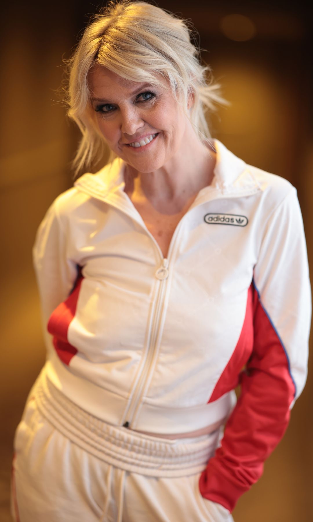 Ashley Jensen wearing a white and red tracksuit