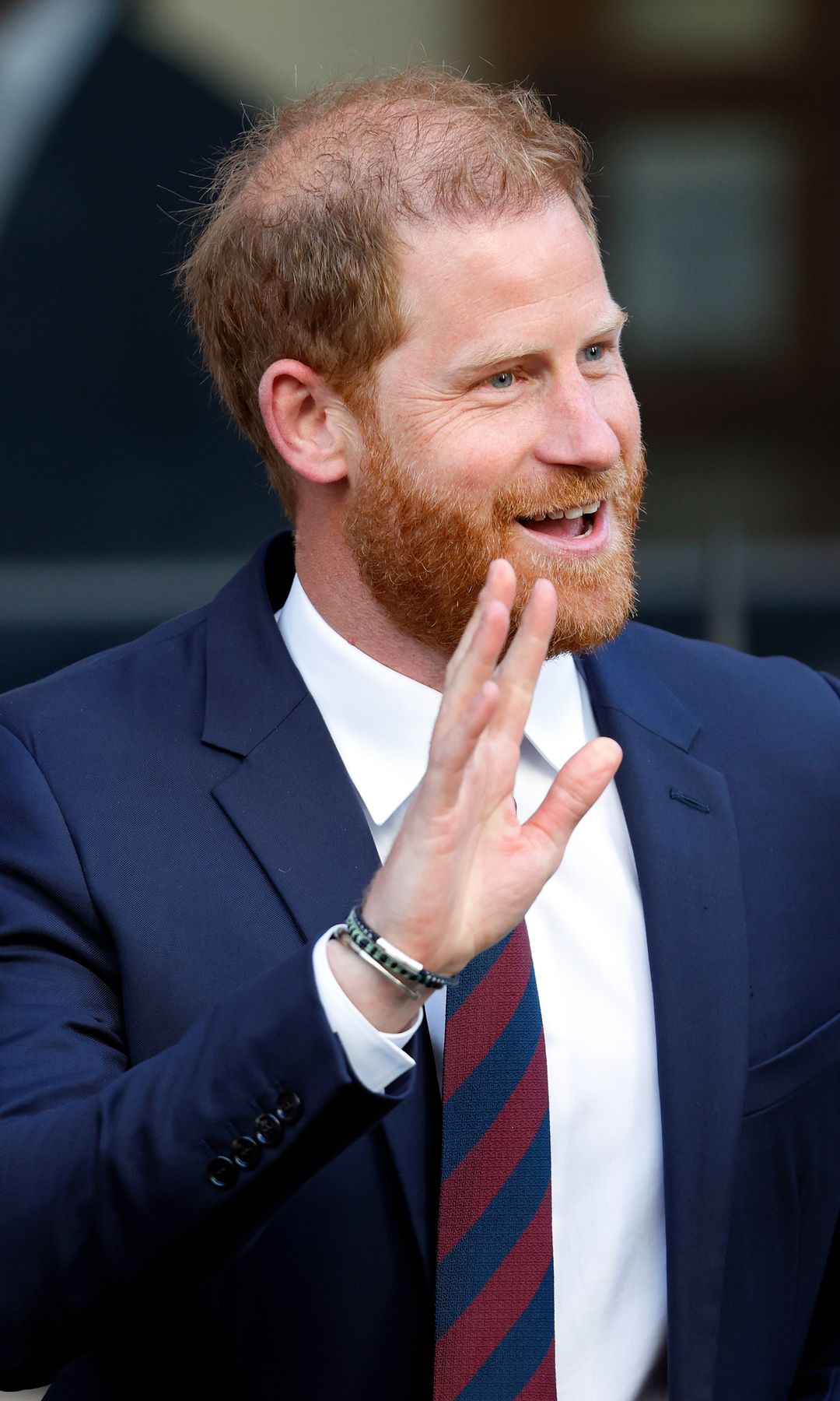 Prince Harry waving as he walks