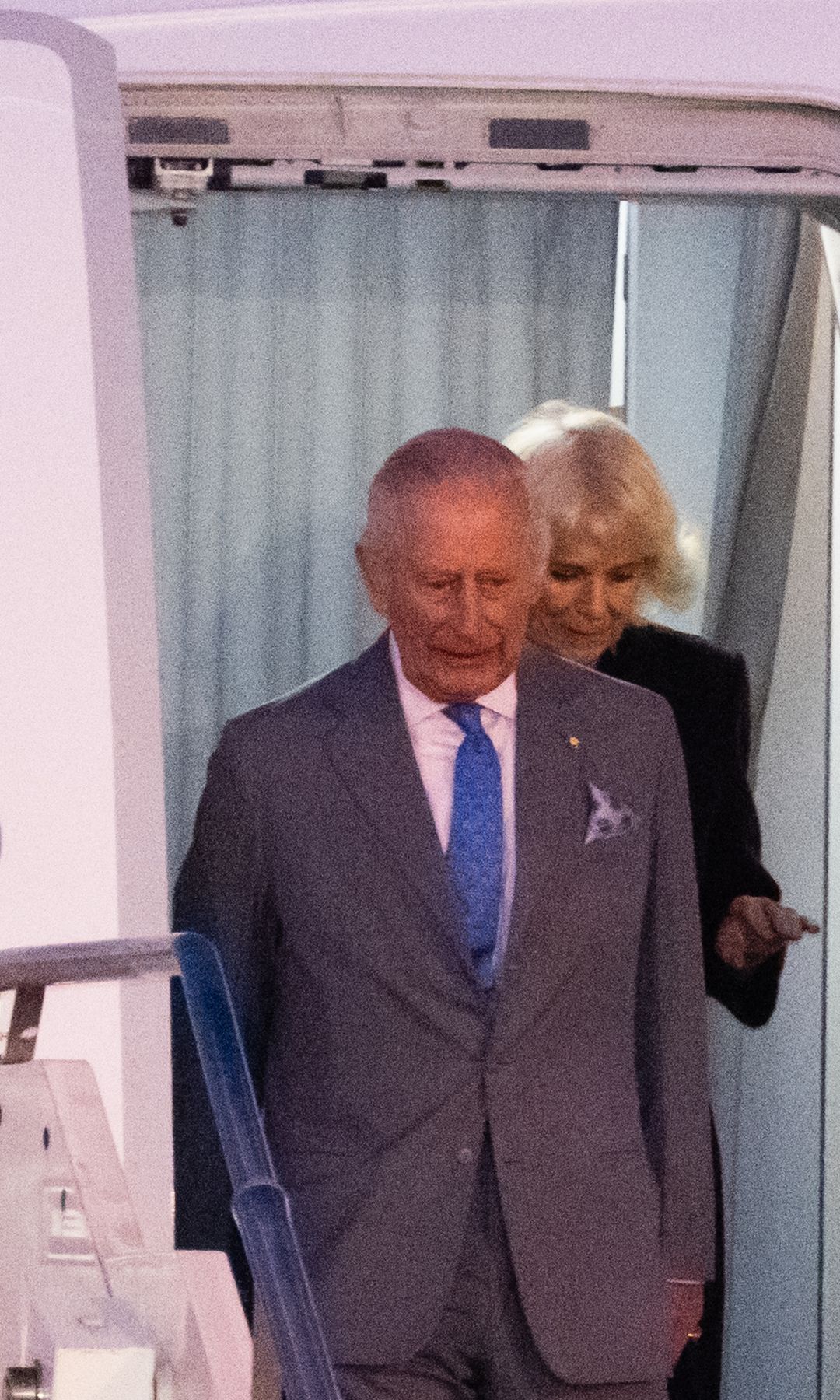 King Charles and Queen Camilla disembarking a plane