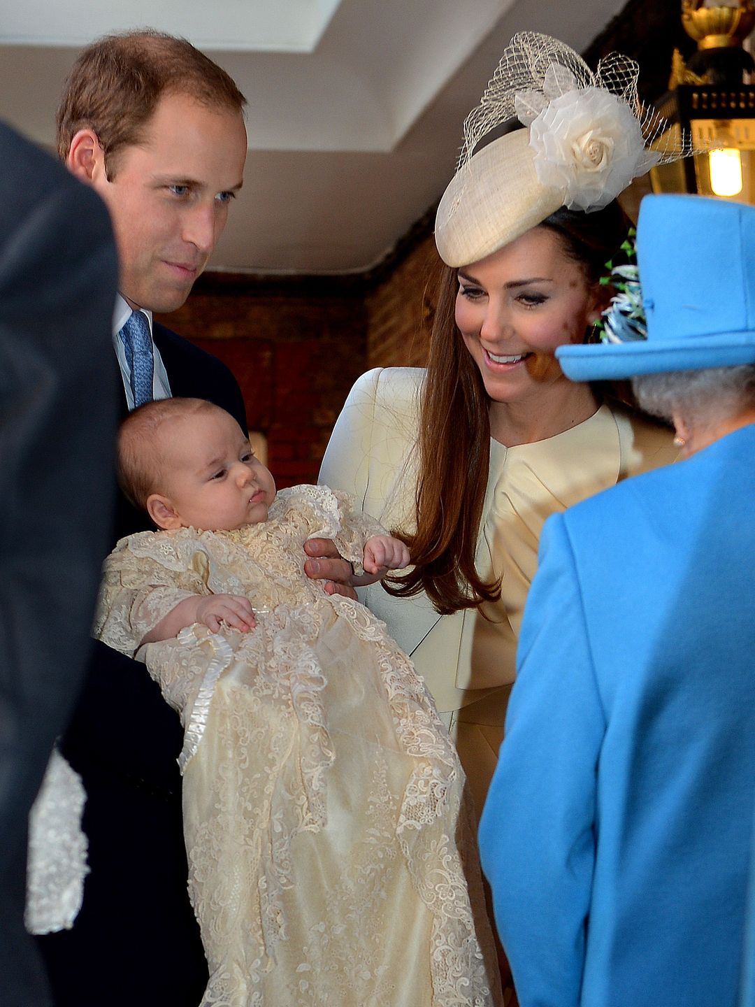Queen Elizabeth II with Prince William and his wife Catherine at their son Prince George's christening 