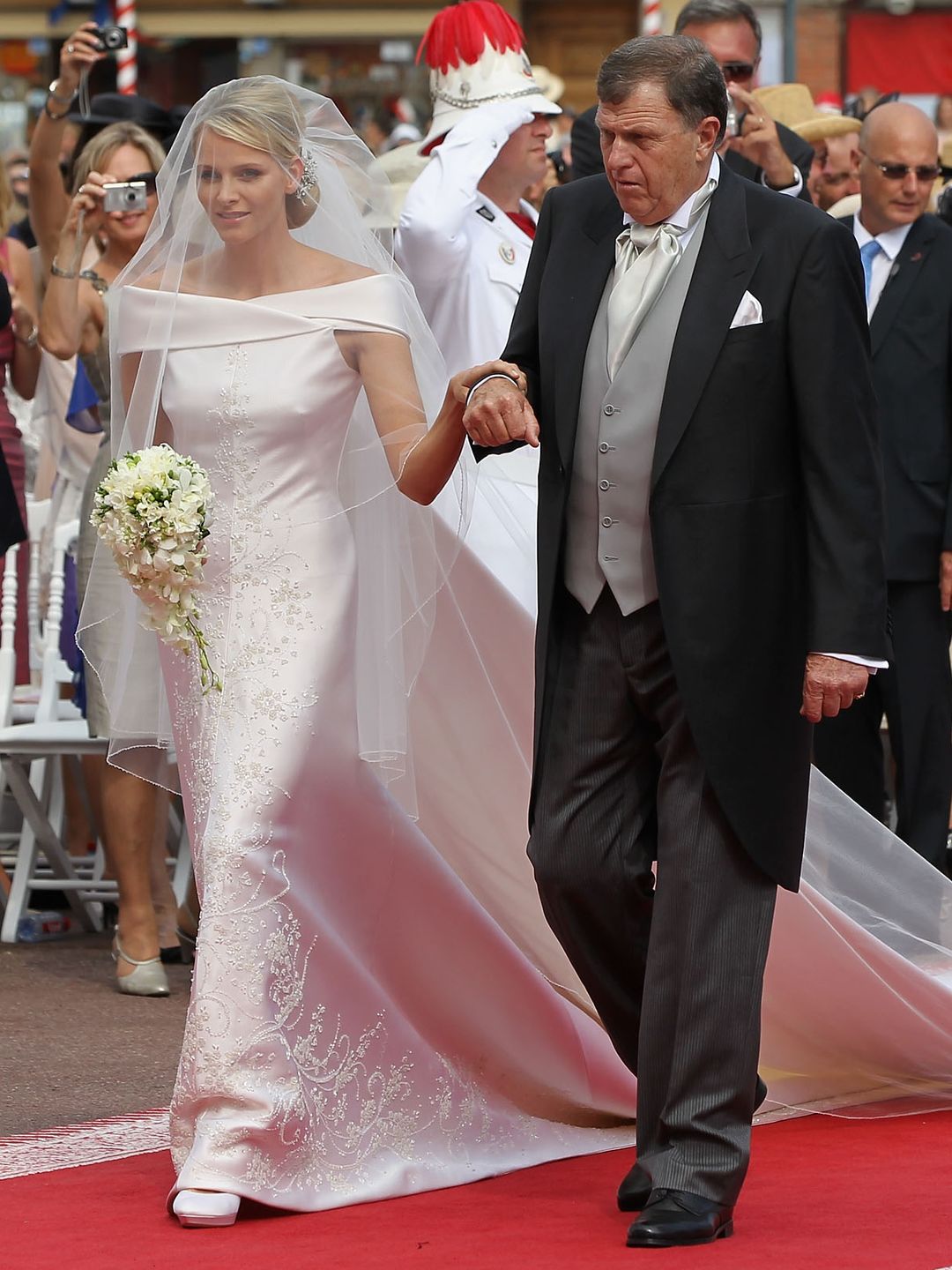 Princess Charlene of Monaco holding hands with Michael Kenneth Wittstock as she walks down the aisle