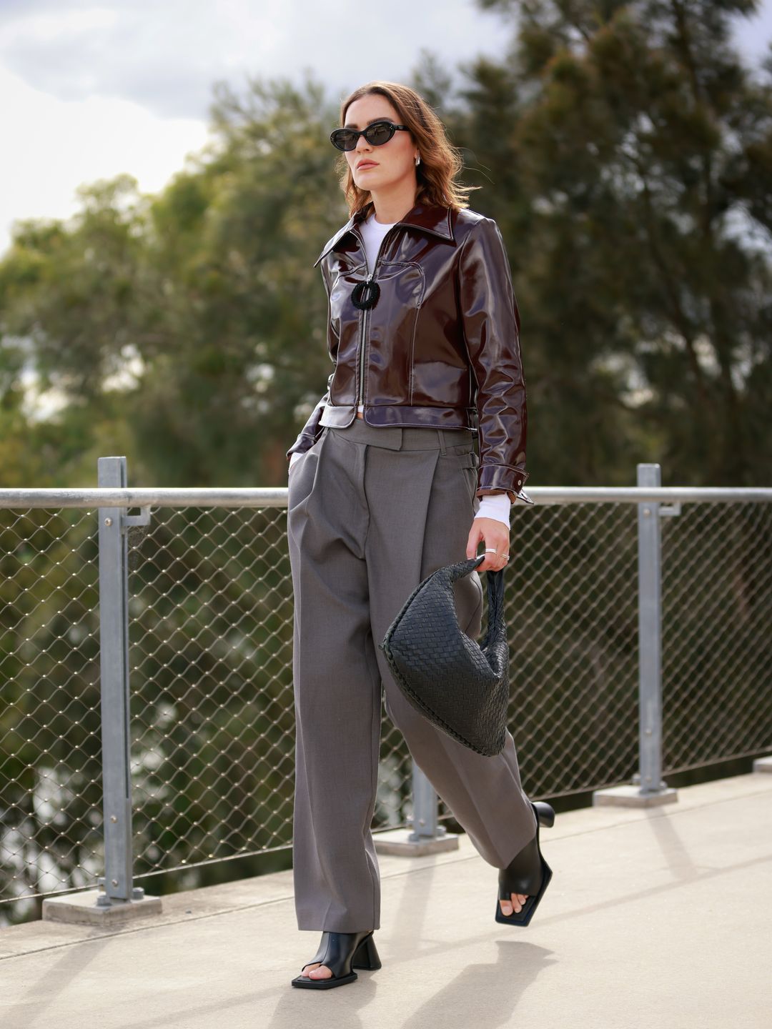 Holly Lyle wears a glossy boxy jacket, tailored trousers and mules 