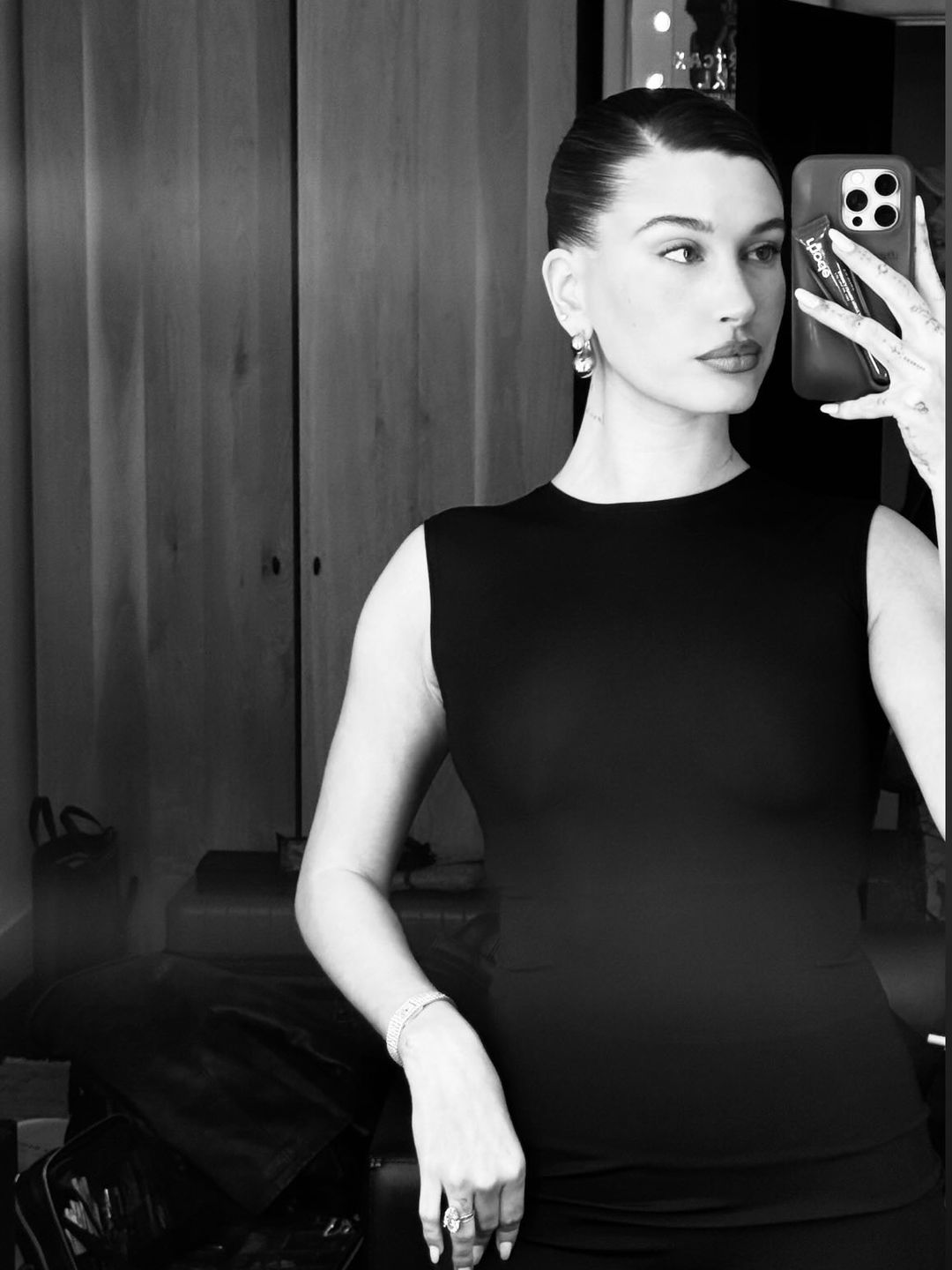 Hailey Bieber shares a selfie wearing a black bodycon dress