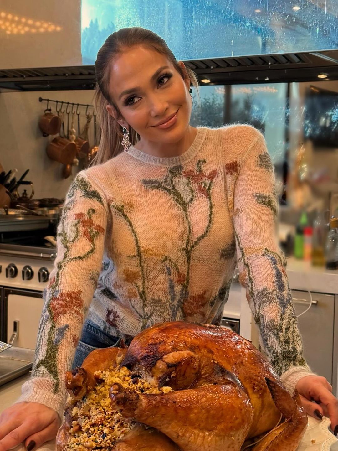 Jennifer Lopez poses with a turkey in a floral knit jumper