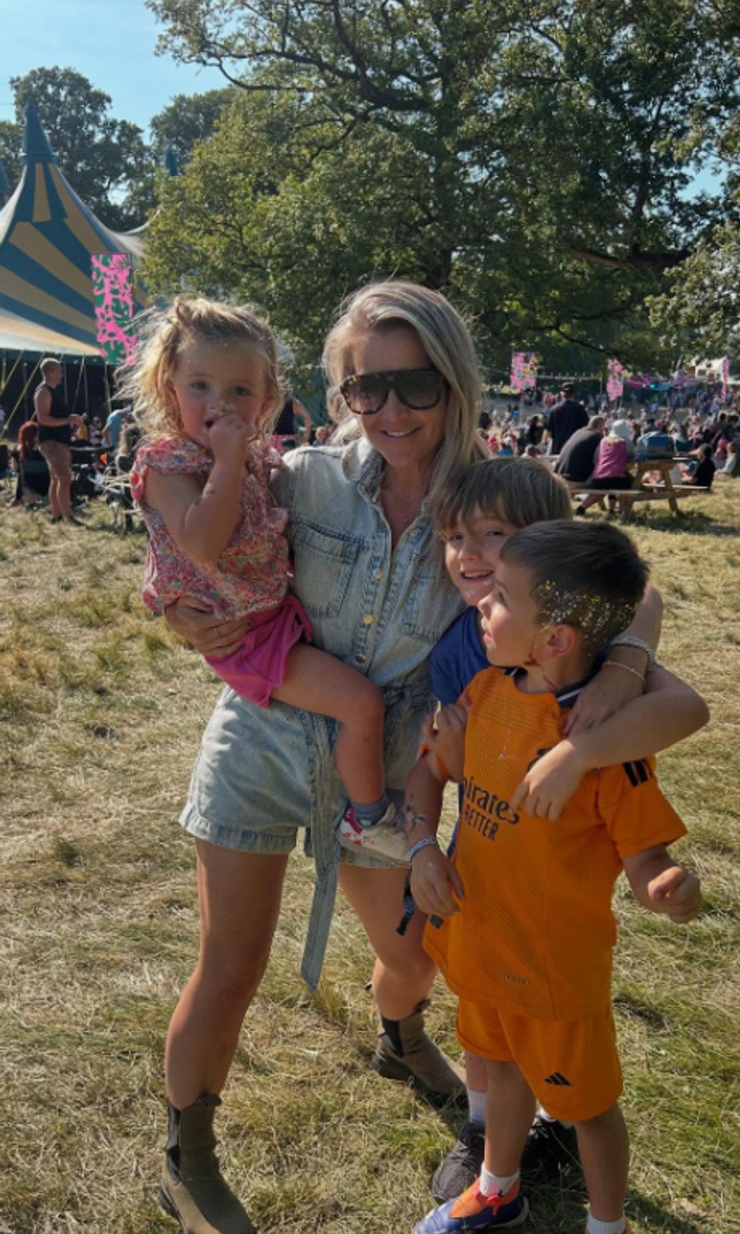Helen Skelton in a denim outfit with her three children