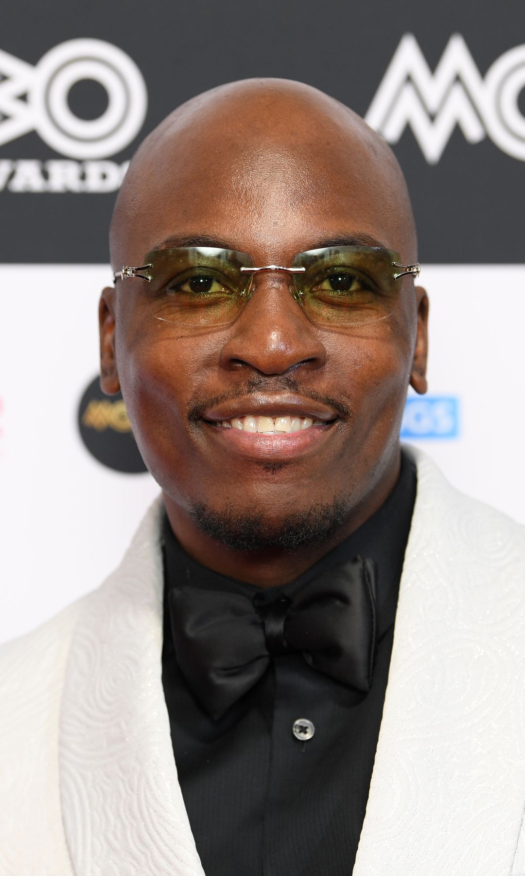 Eddie Kadi wearing a white suit