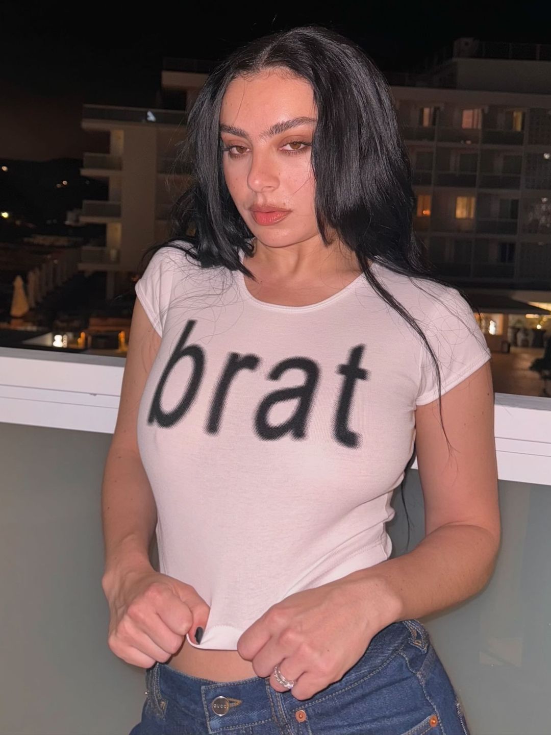 Charli XCX poses in a “Brat” T-shirt