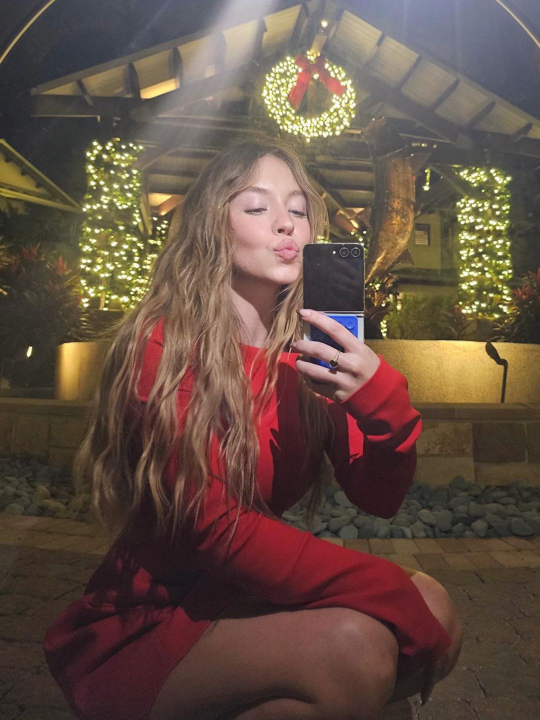 Sydney Sweeney wears a red mini dress in a mirror selfie