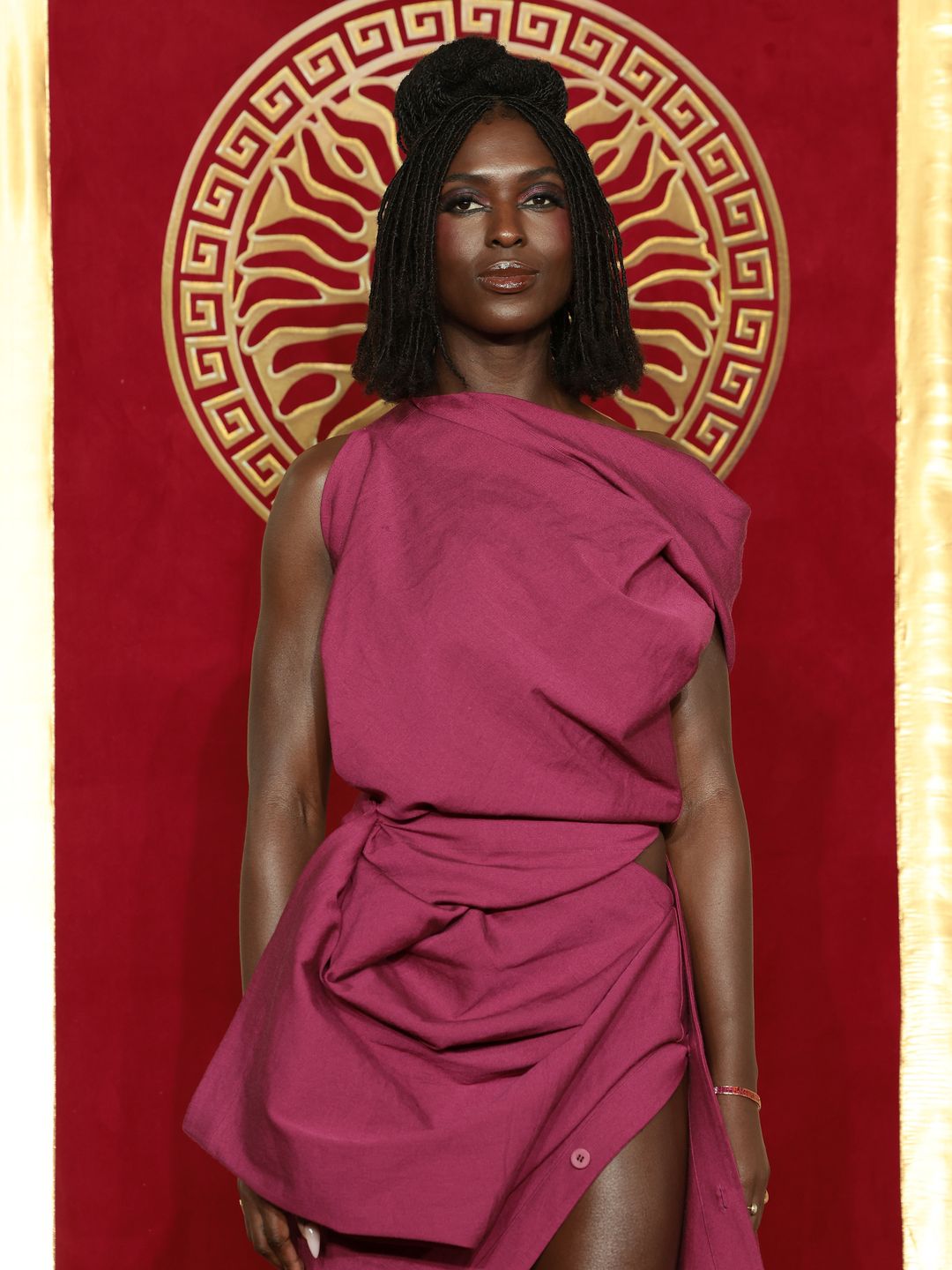 Jodie Turner-Smith in maroon dress