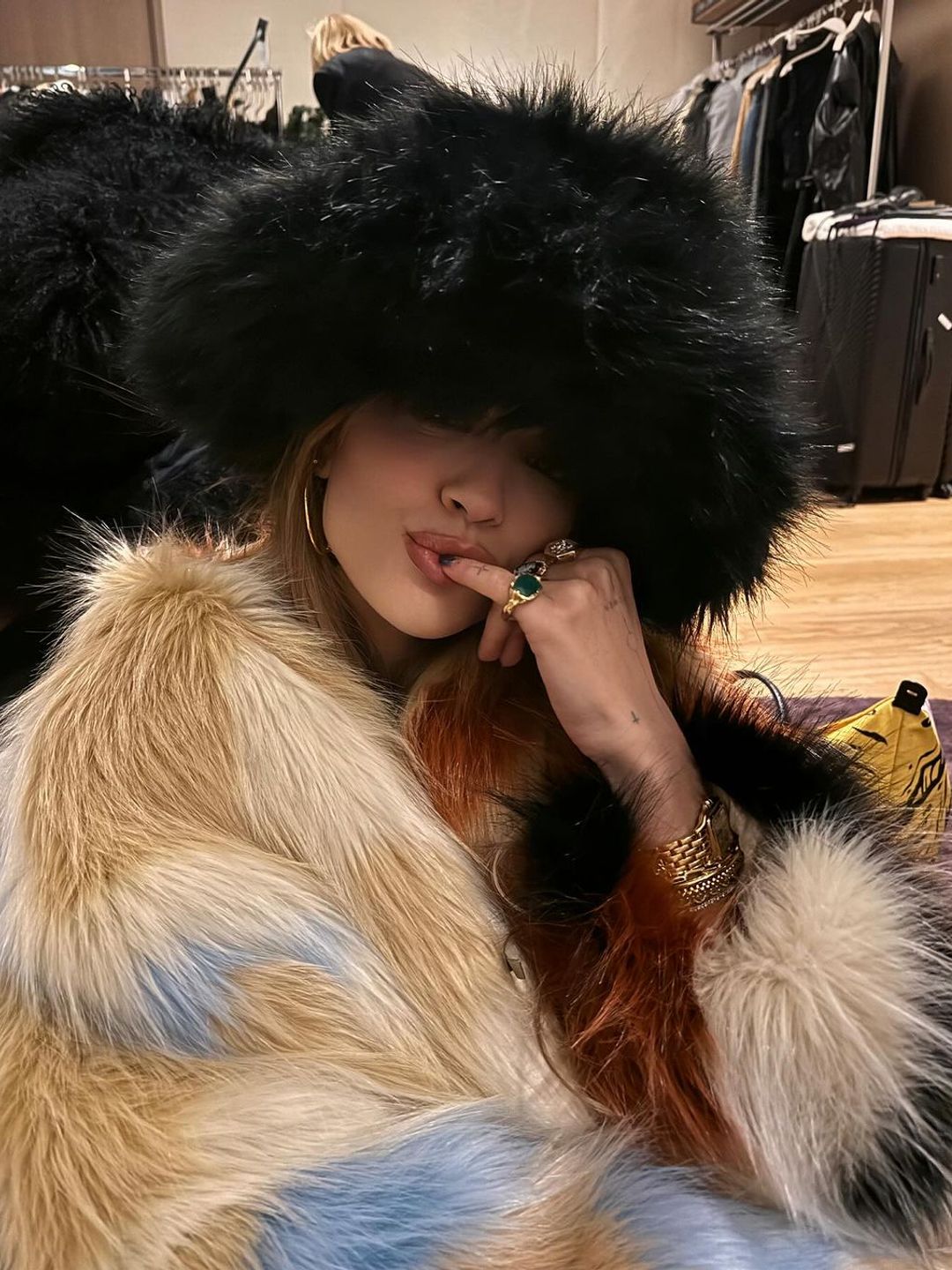 Rita Ora wearing a black fluffy hat 