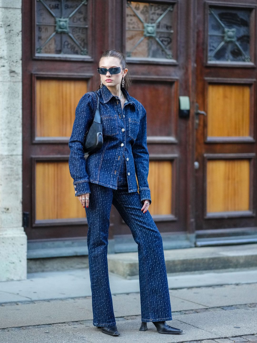 A Fashion Week teams monogram dark flare jeans with a matching jacket 