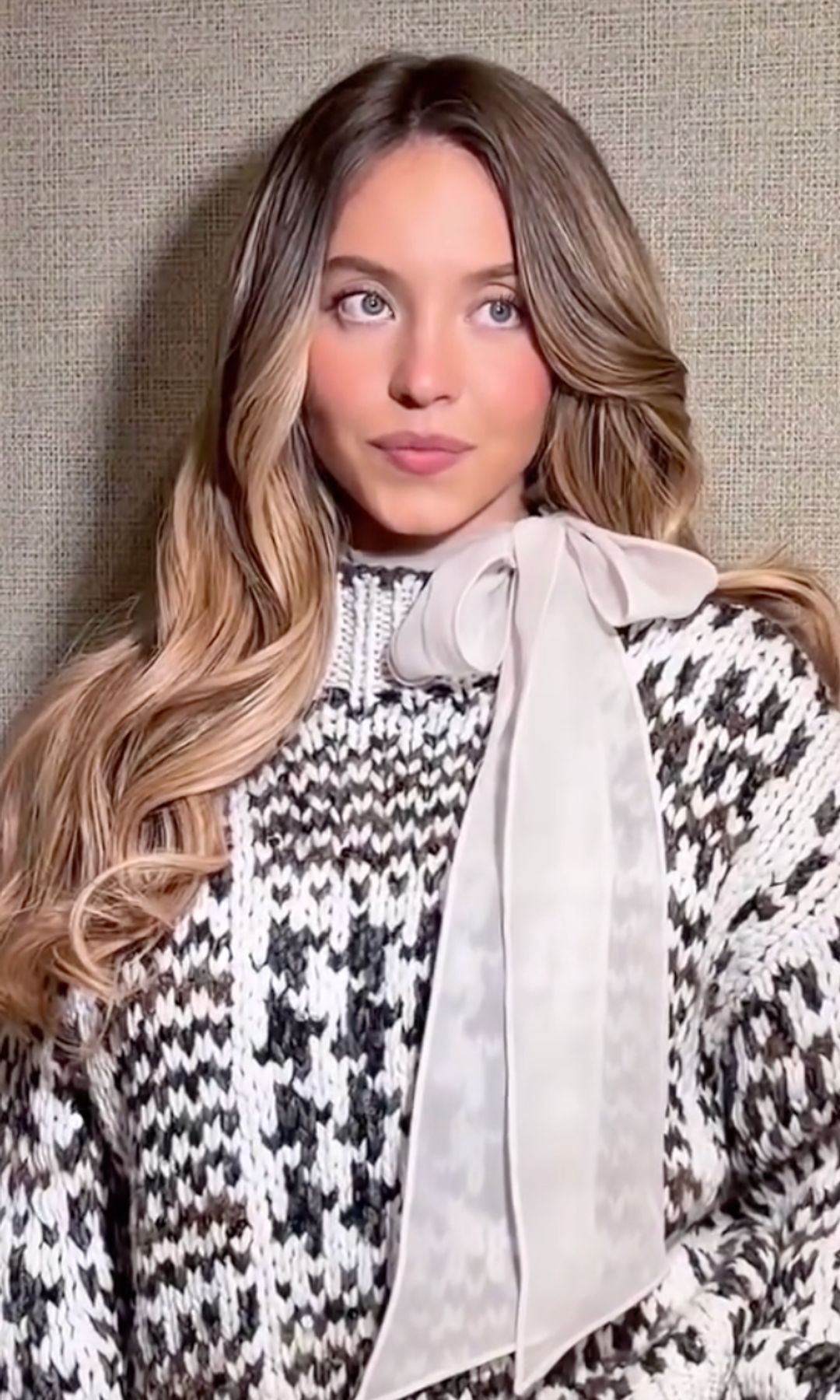 Sydney Sweeney poses in a knitted jumper 
