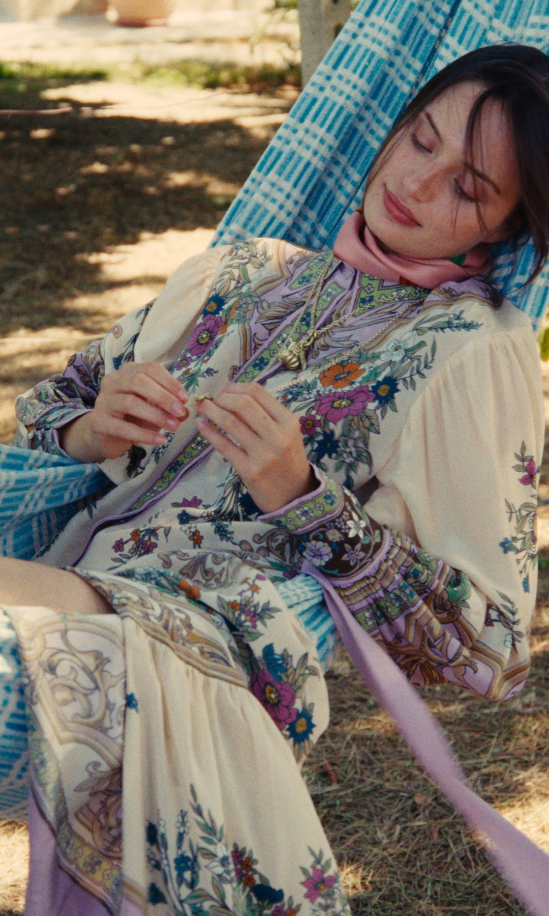 woman lying in hammock in printed dress