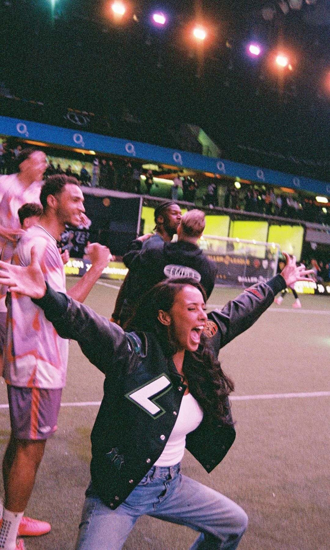 Maya Jama shares a photo of herself celebrating on the side of a football pitch