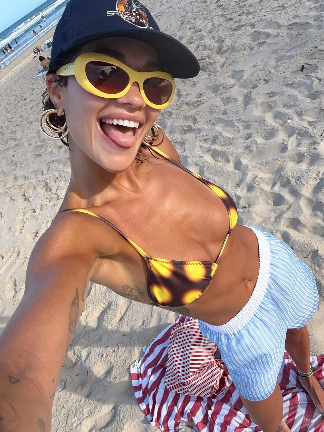 Rita Ora poses on the beach in her bikini