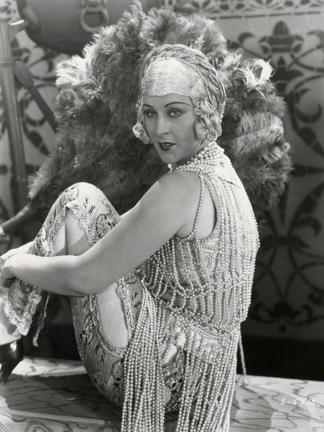 Anita Garvin in a costume constructed from strings of pearls 