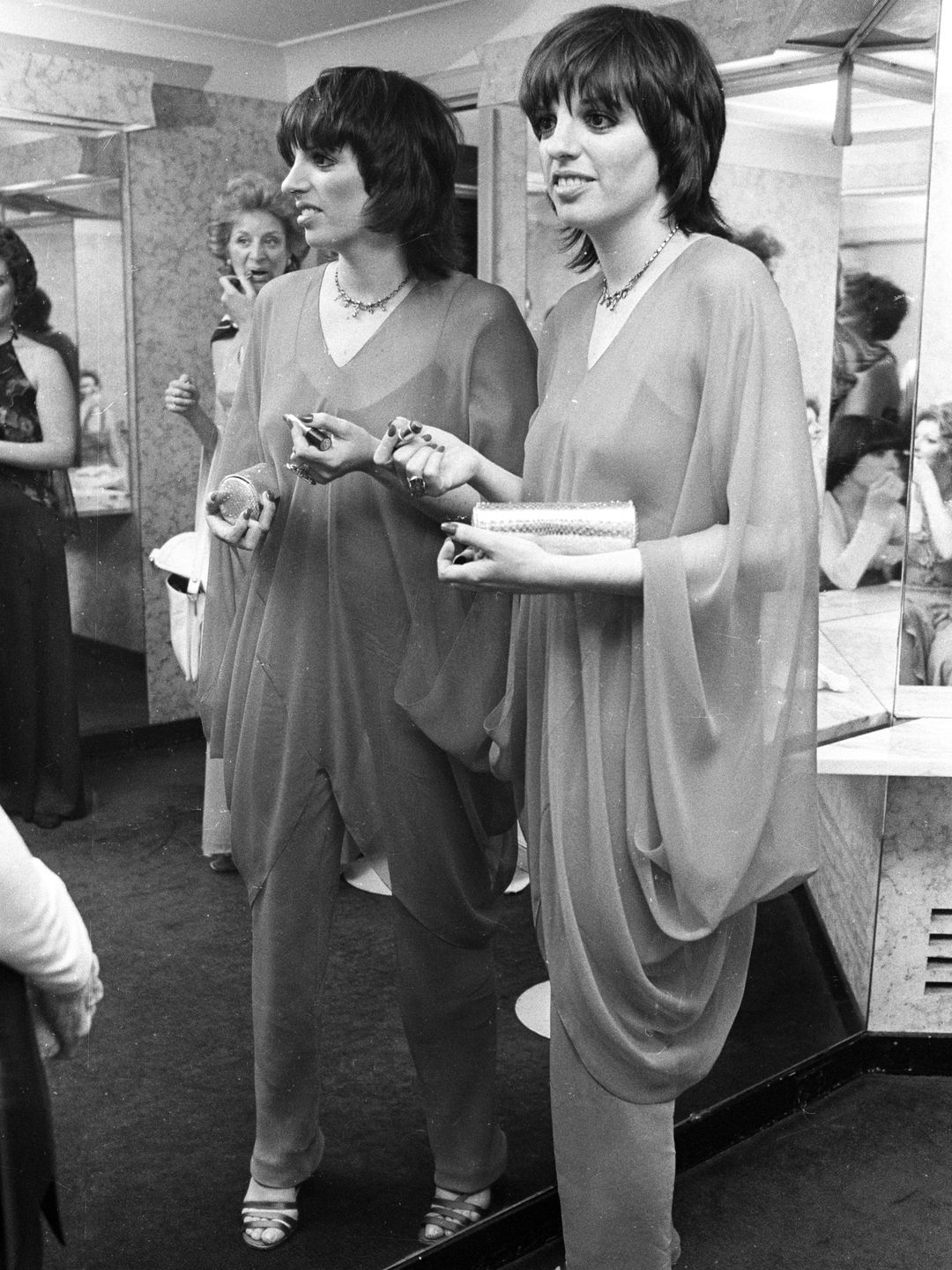 Liza Minnelli at a 1,000 guest 1 a.m. breakfast-disco party following friend Liza Minnelli's premiere for her new movie 'New York, New York' at Studio 54 in a sheer tunic and trousers. 