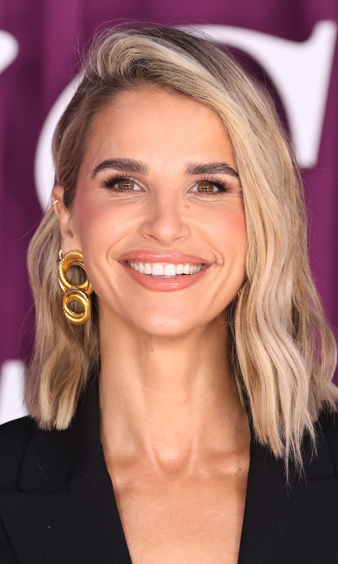 Vogue Williams smiling in a black dress