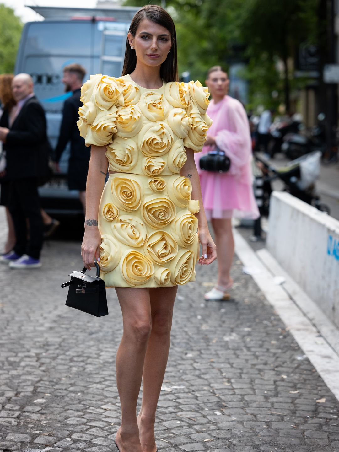 Kelly Piquet wearing a yellow 3D rosette-adorned mini skirt 