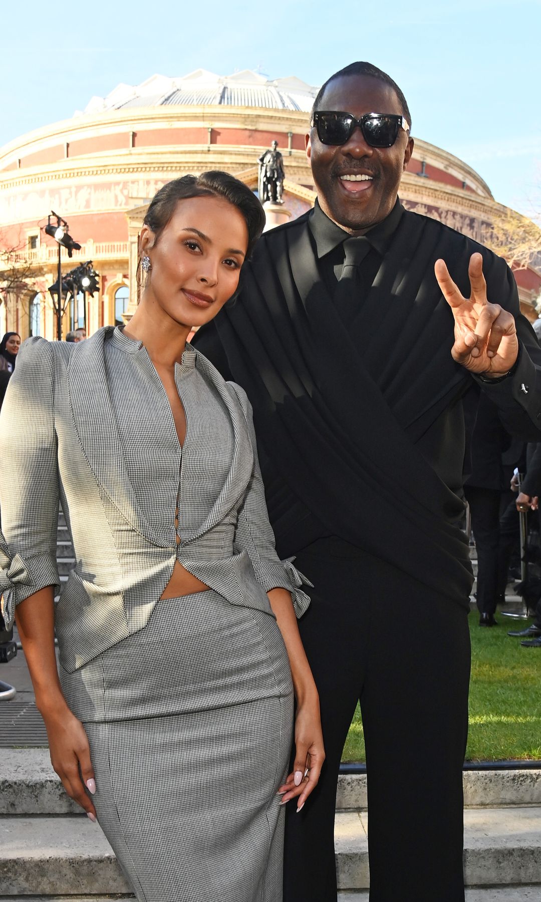 Maya Jama and Idris Elba attend The Olivier Awards 2025 with Mastercard at The Royal Albert Hall, posing for a photo outside the venue