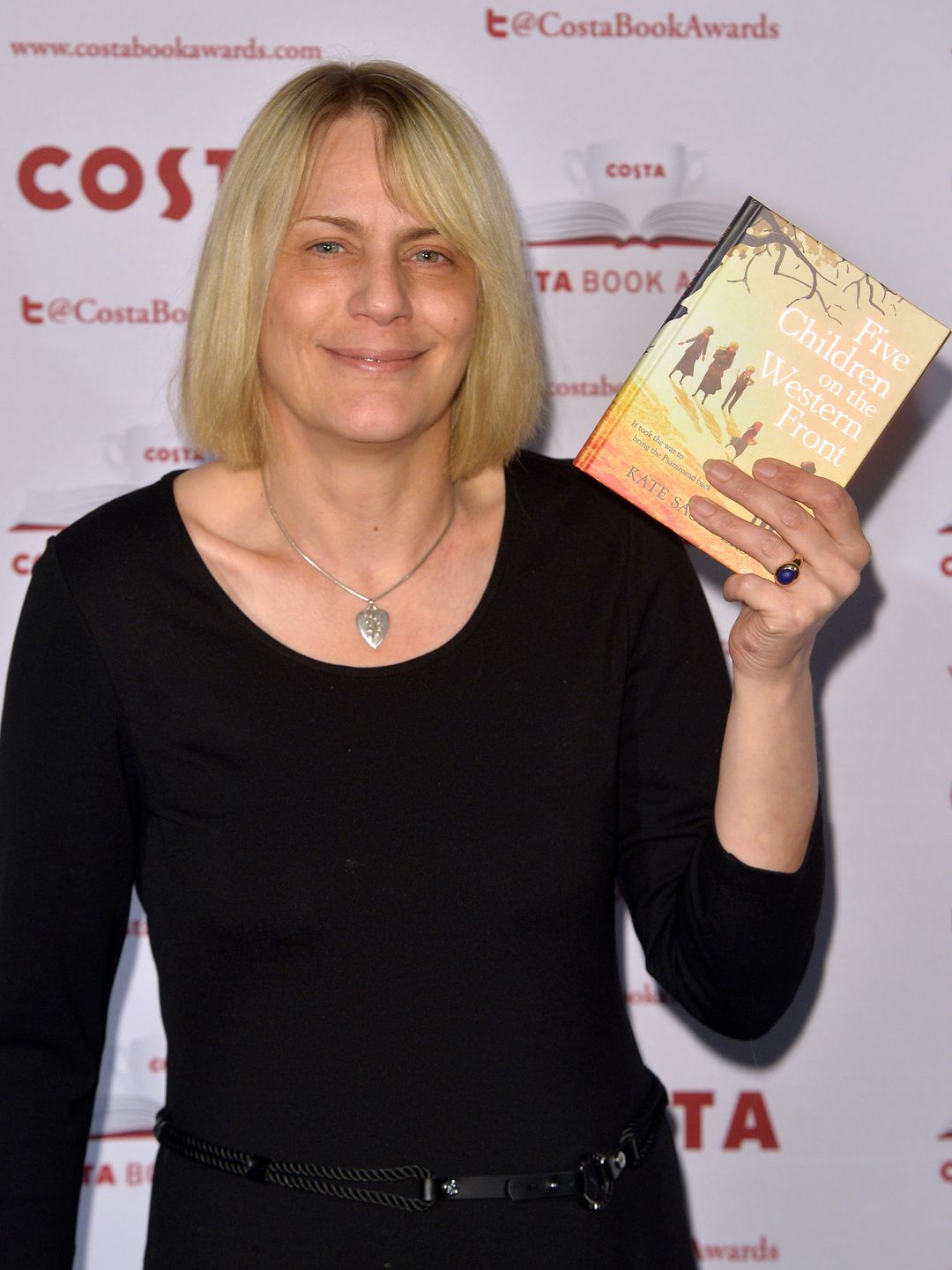 Kate Saunders holds up book at Costa Book Awards