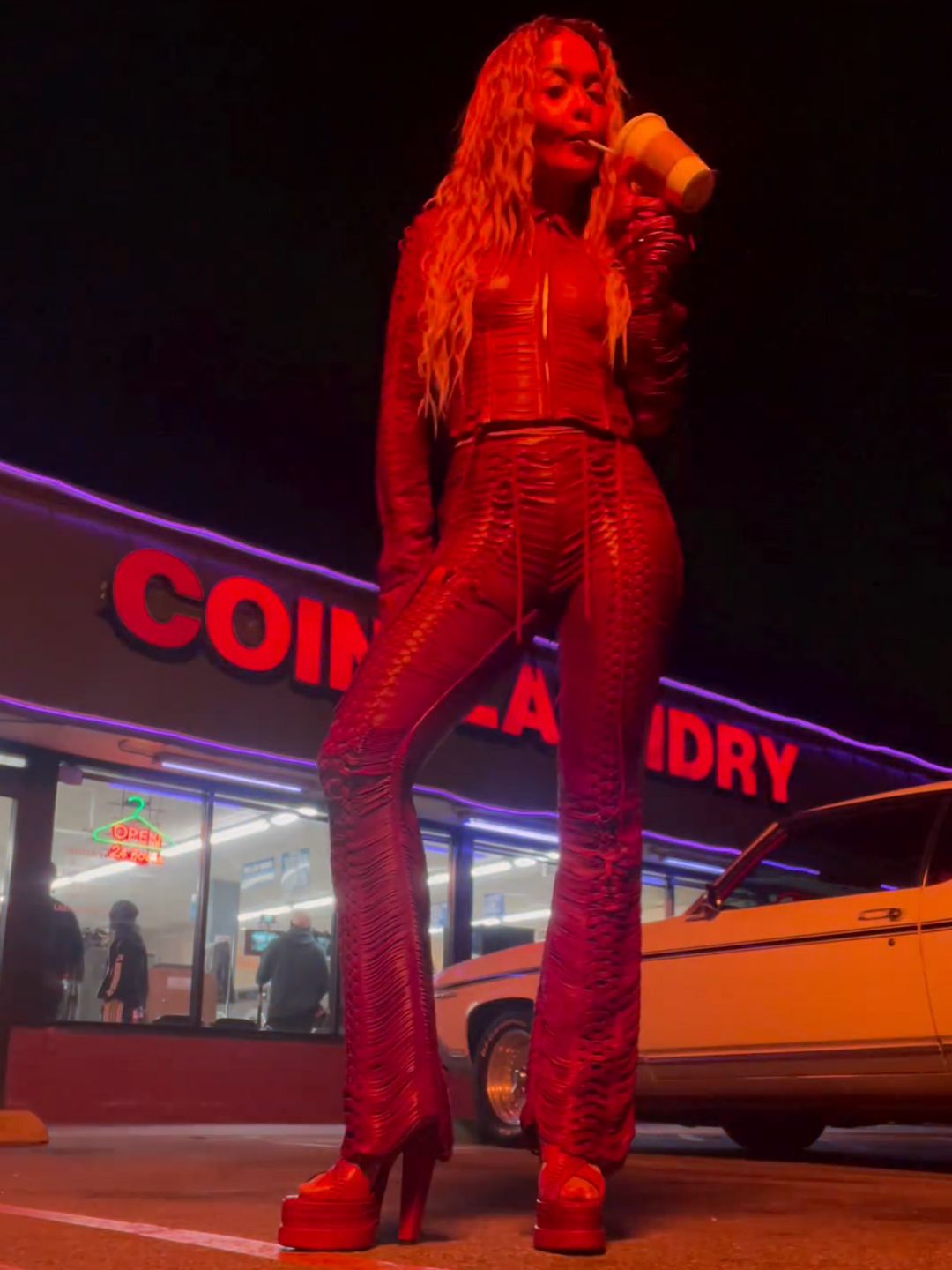 Rita Ora with long hair in red leather outfit 