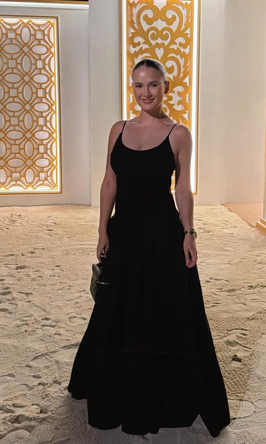 Molly Mae poses in a black sundress