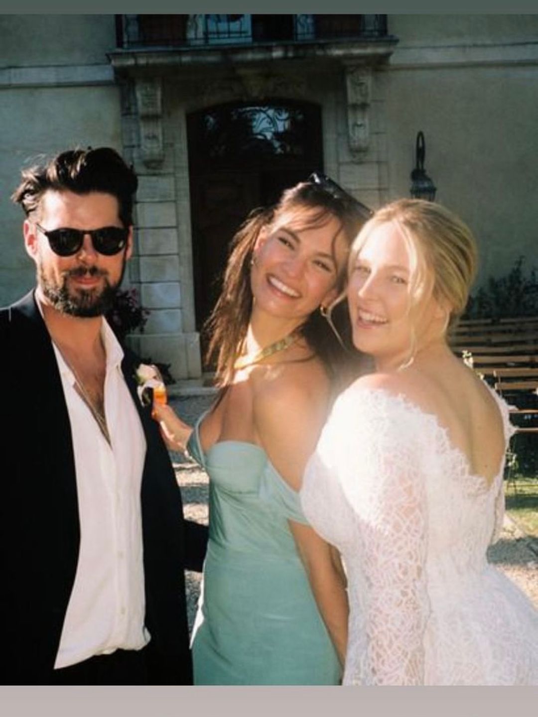 Lily smiling with friends at a wedding 