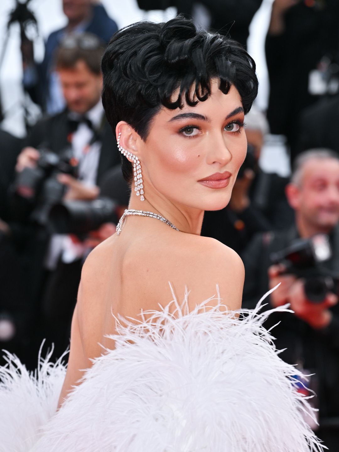 Grace Elizabeth with glittery cheeks and black cropped hair 