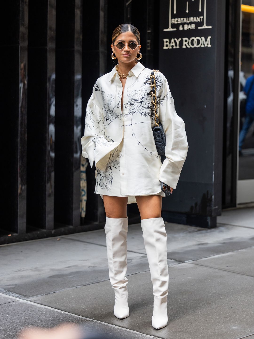 Rocky Barnes layers a white printed shirt over an A-line skirt 
