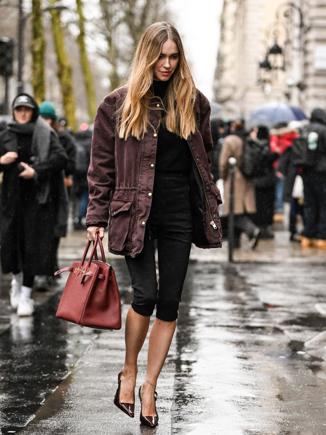 Pernille Teisbaek is seen wearing a maroon jacket, black top, black shorts, black heels and maroon Hermes bag outside the Hermes show during the Womenswear Fall/Winter 2024/2025