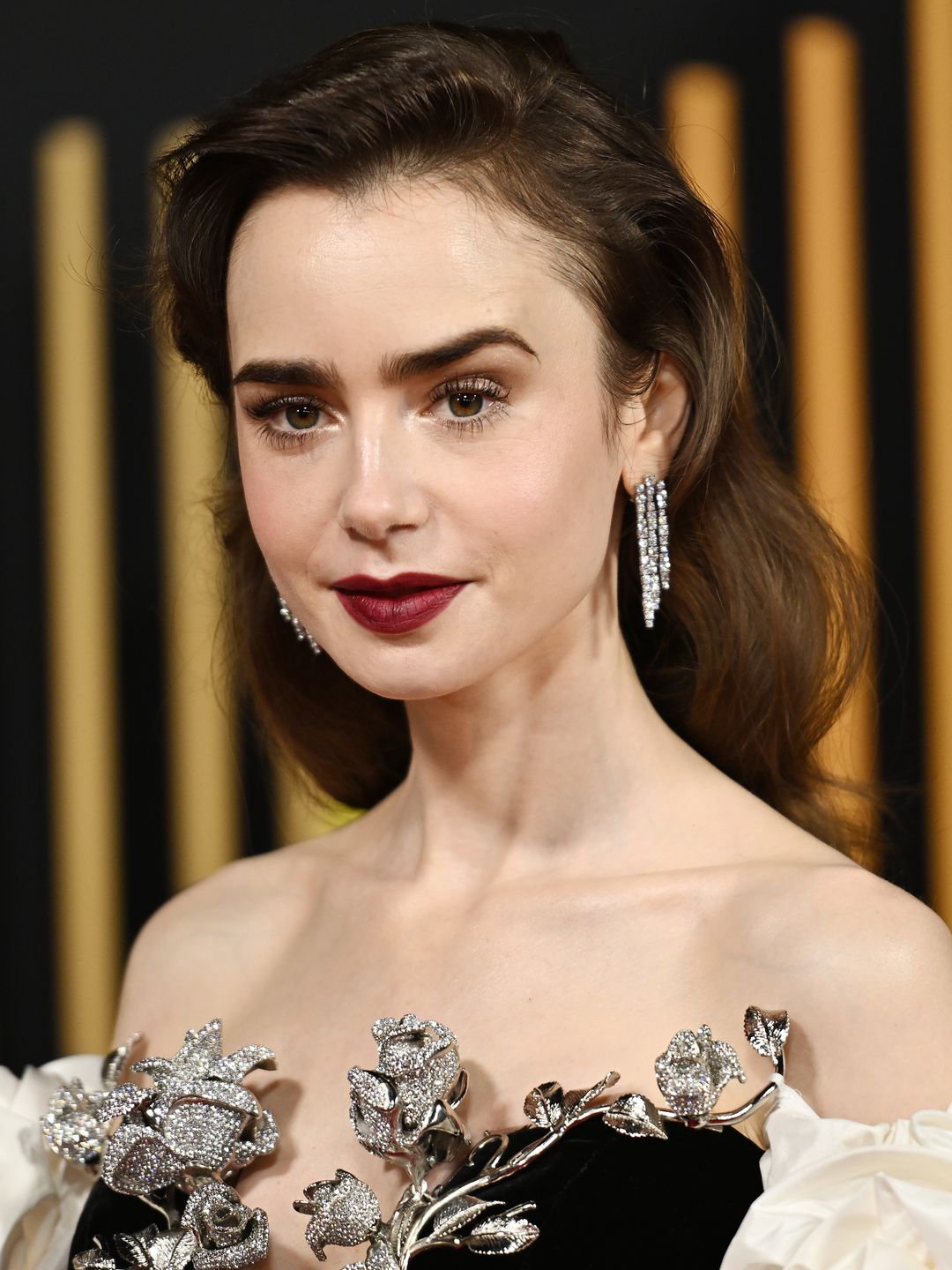 Lily Collins wearing a wine-hued lip at the BAFTAs 
