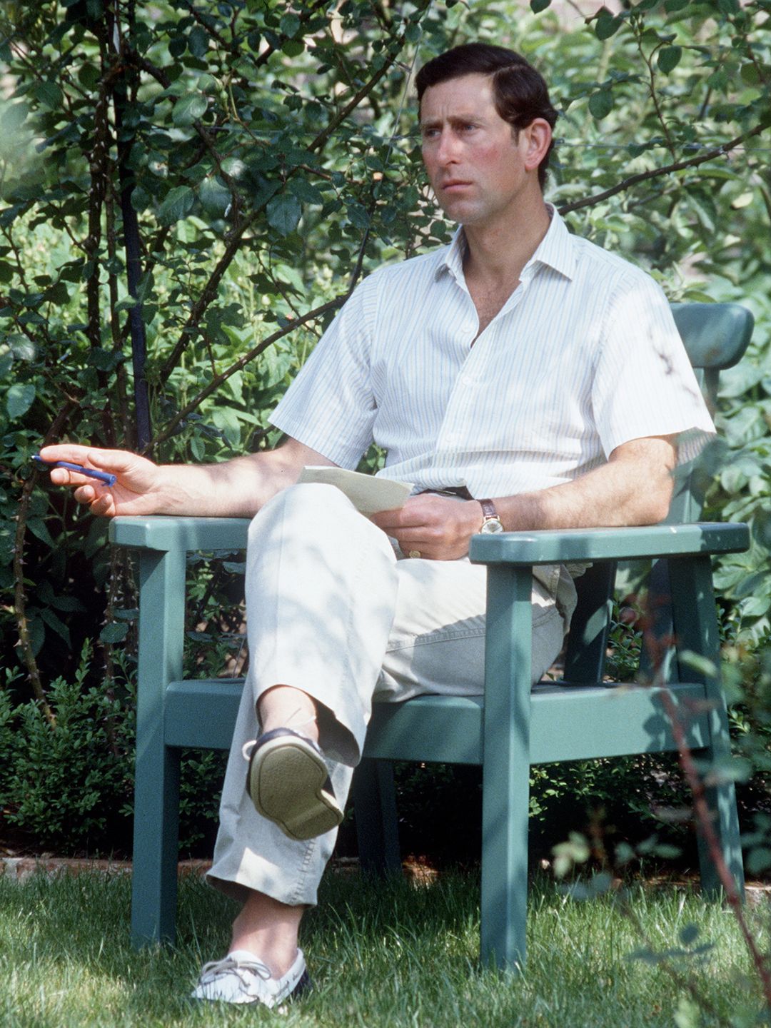 King Charles sitting In his garden at Highgrove in Gloucestershire