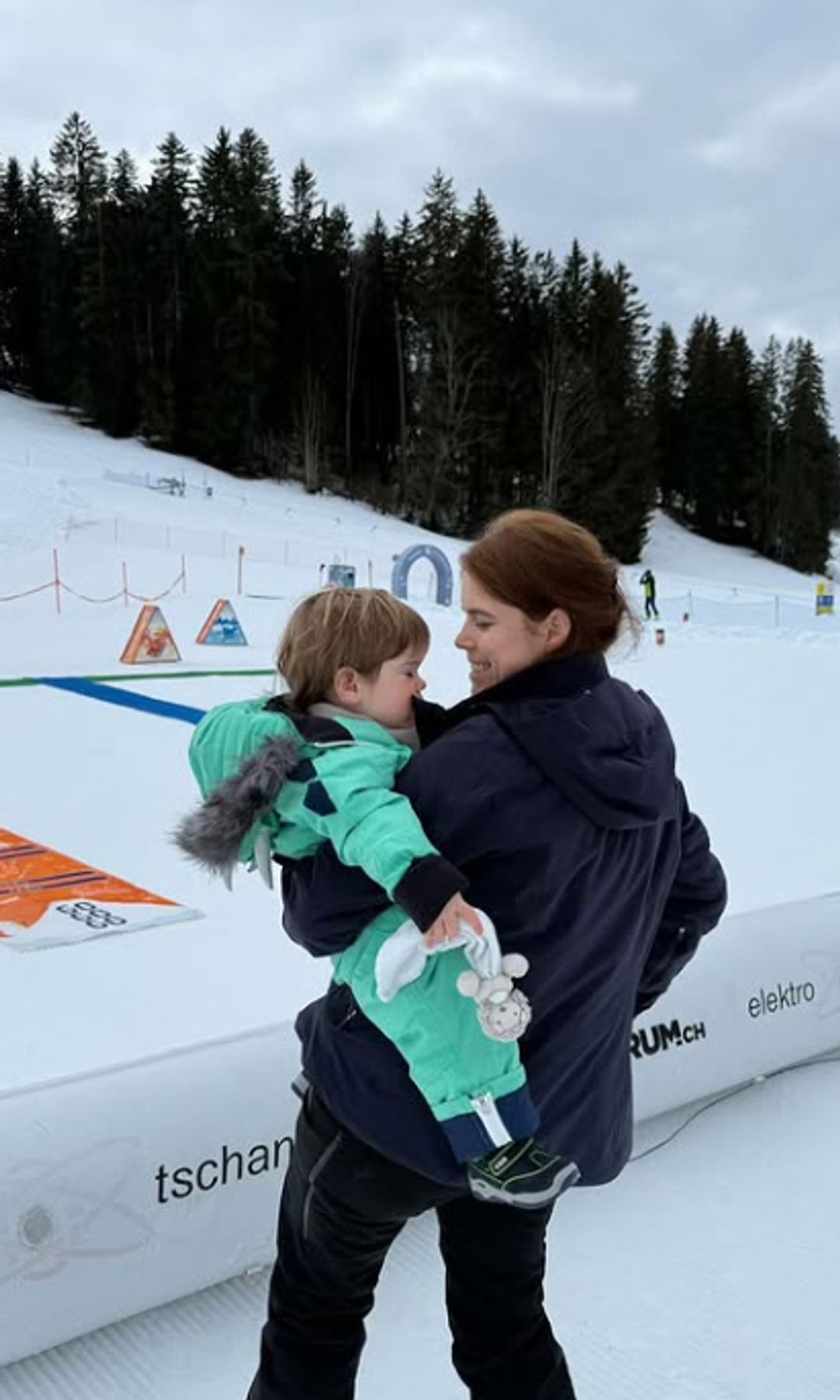 Princess Eugenie holding her son Ernest on a skiing holiday