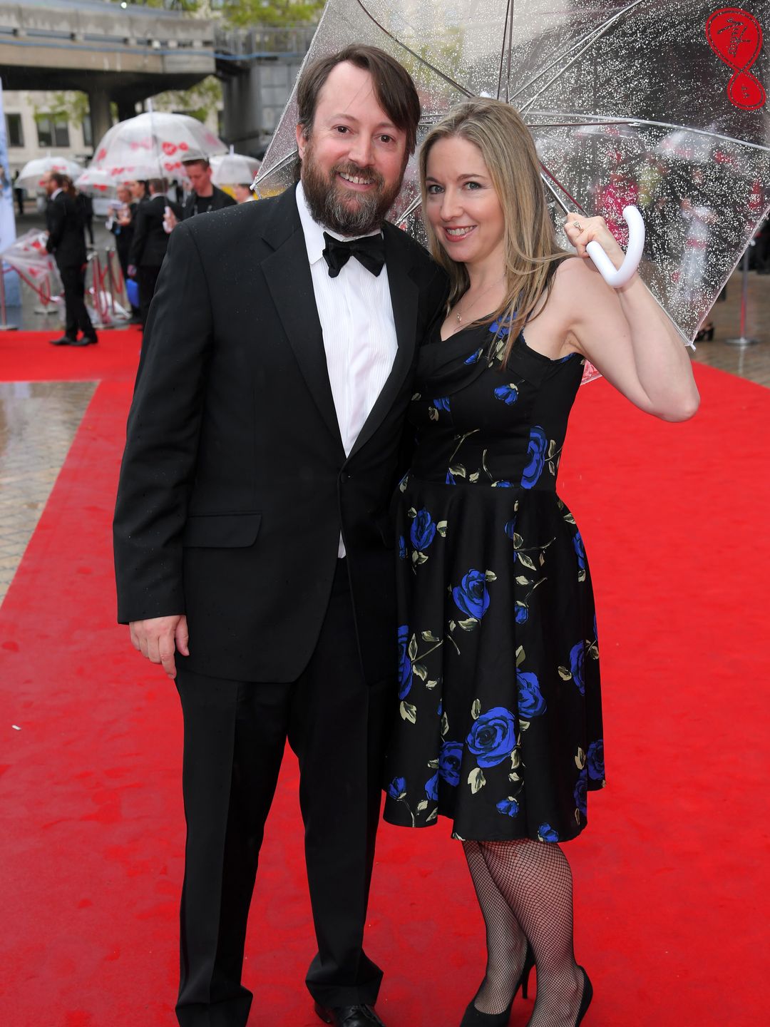 couple on red carpet in the rain