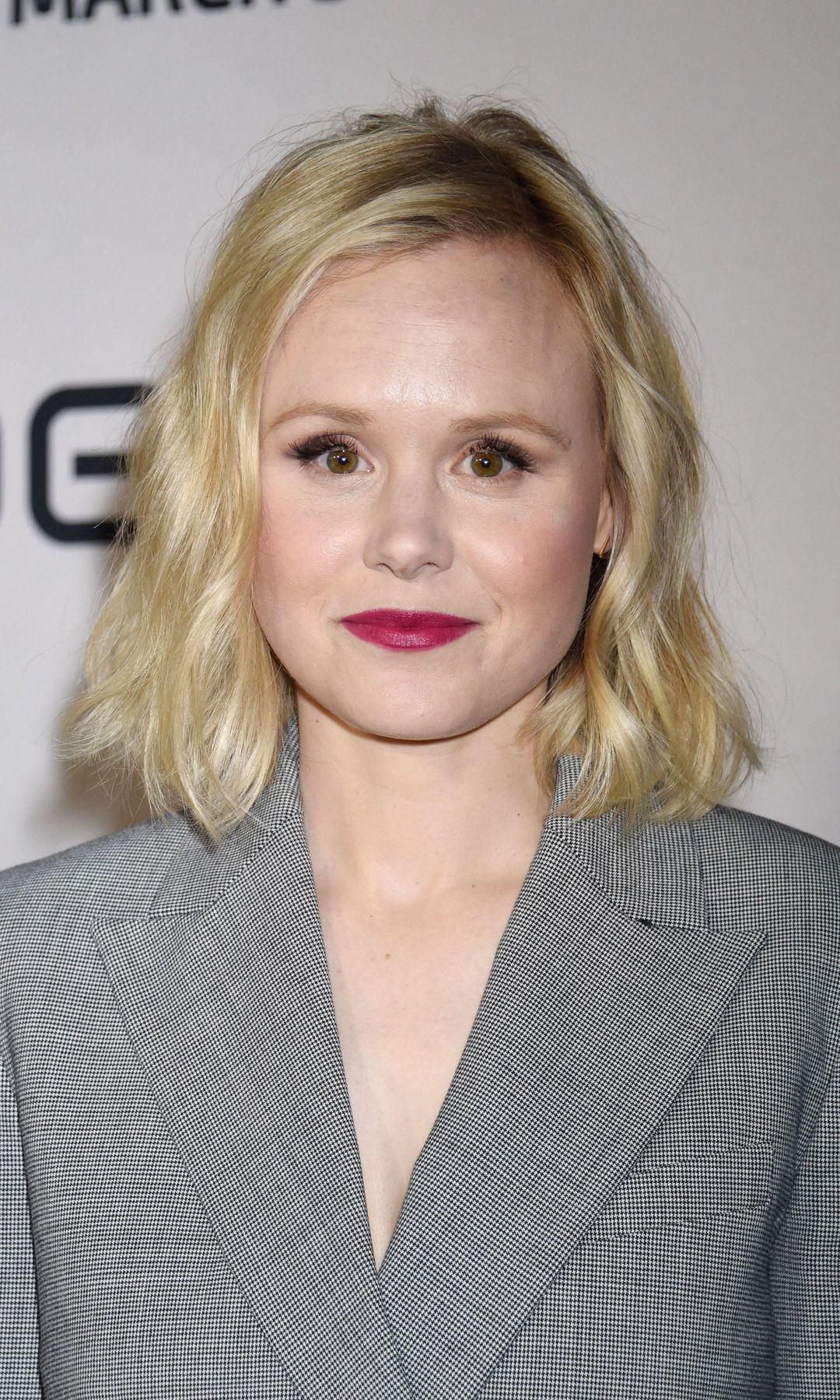 Alison Pill in a grey suit