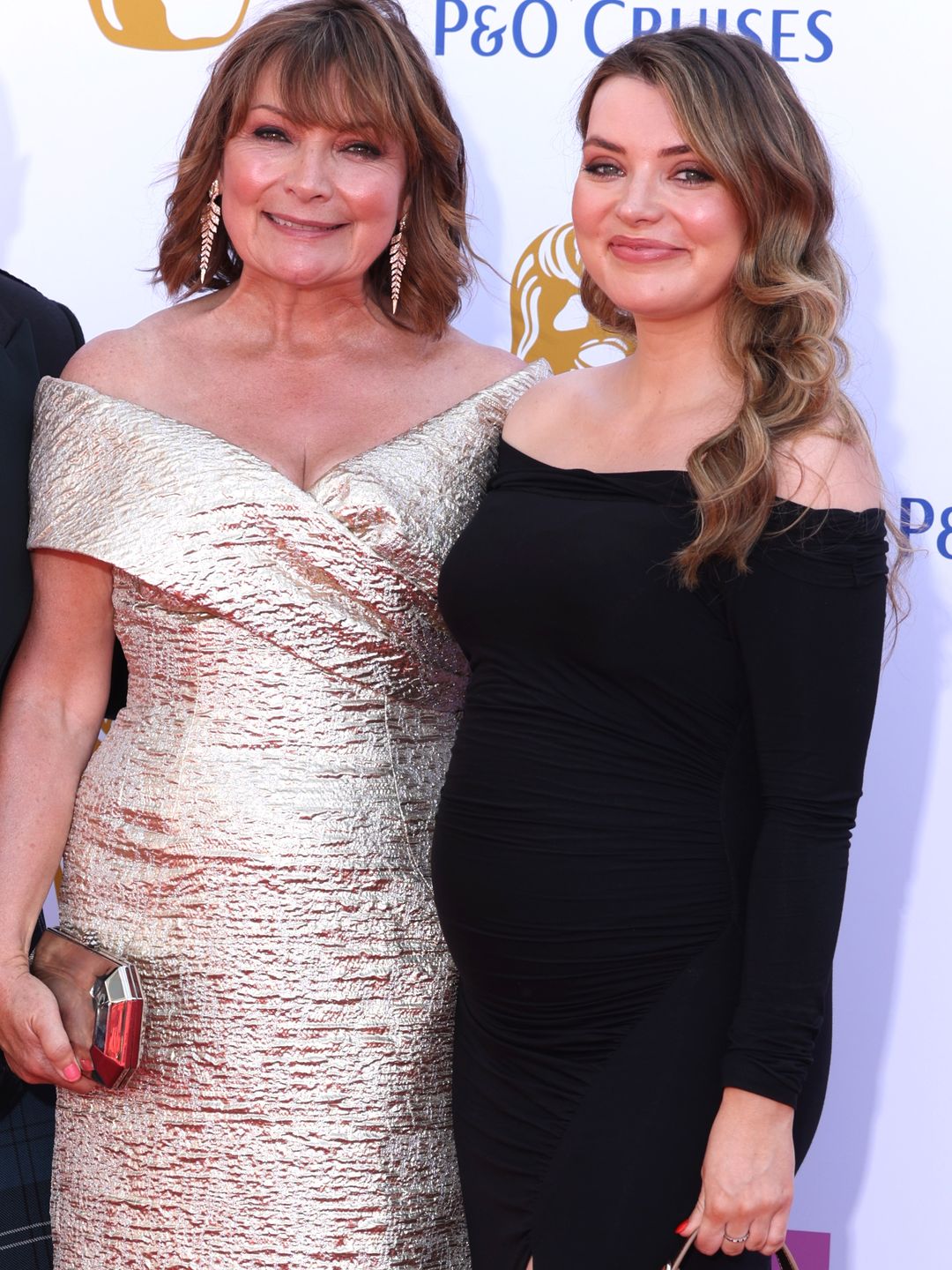 Lorraine Kelly in a gold dress with her daughter Rosie in a bump-skimming black dress
