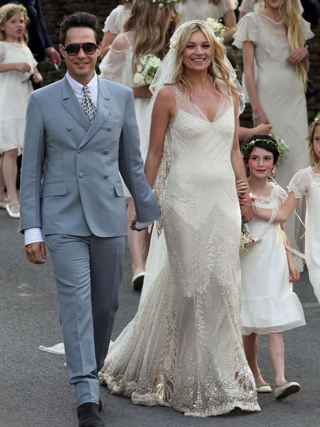 Kate Moss and Jamie Hince walk outside the church after getting married on July 1, 2011